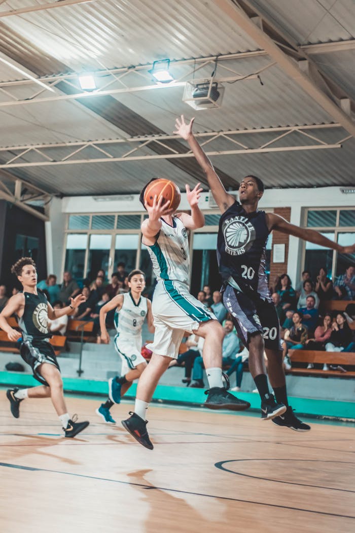 gallery-3 Intense basketball match with players in action on an indoor court.