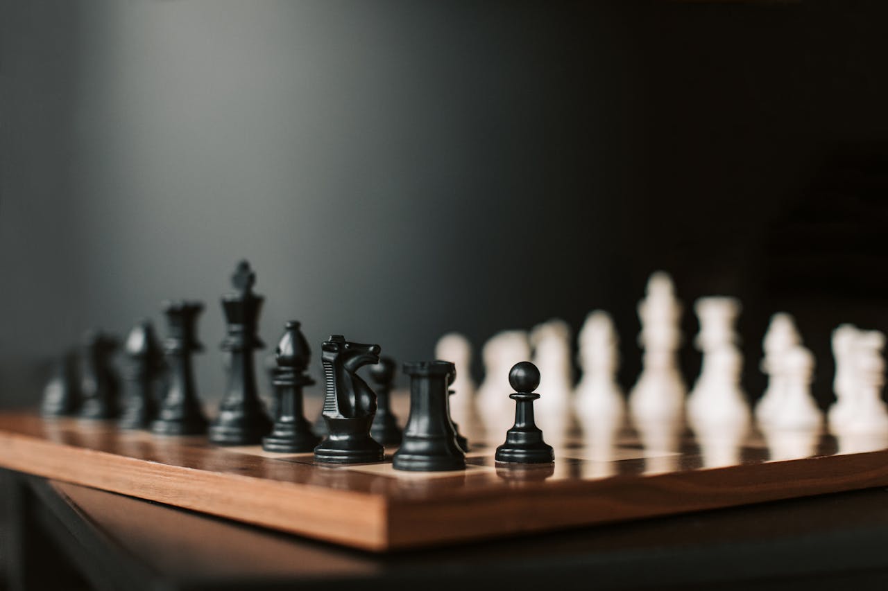 gallery-1 Close-up of a chessboard with black pieces ready to start the game.